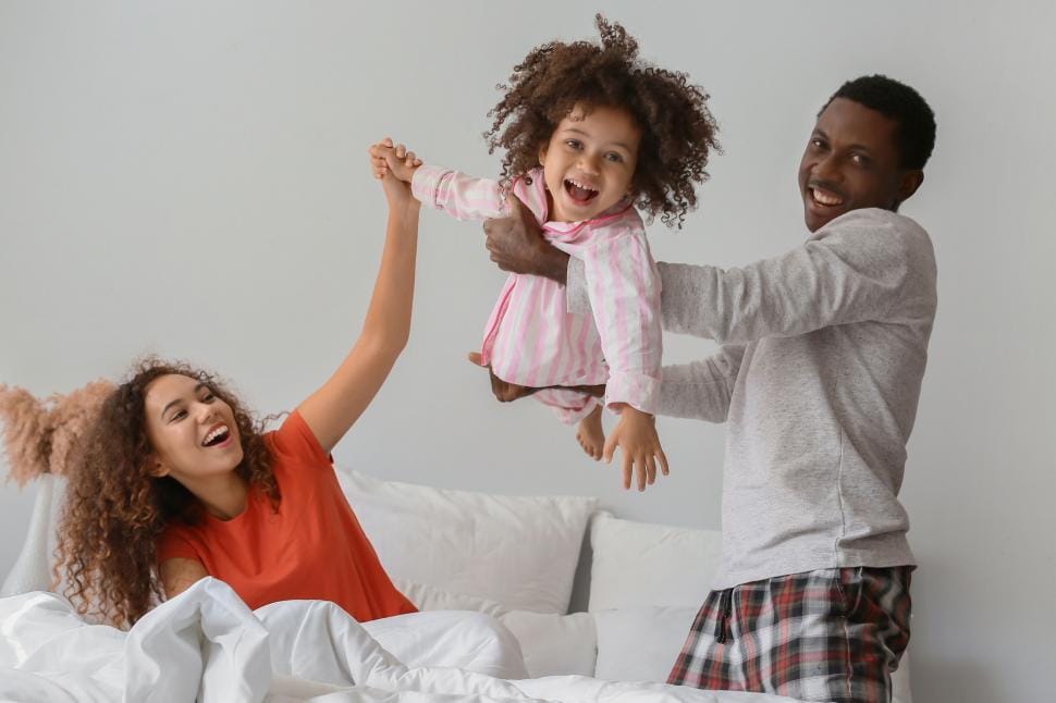 A diverse family sharing a warm, joyful moment together at home