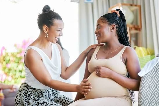 Doula warmly comforting an expecting mother